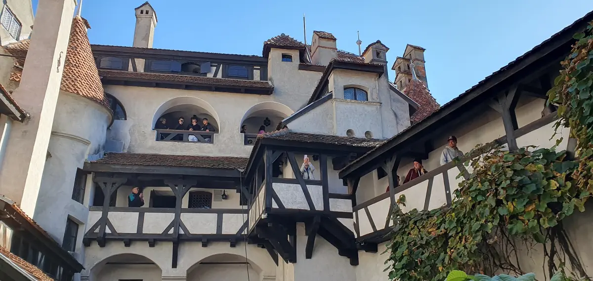 Timber framed galleries and arched windows around a castle courtyard