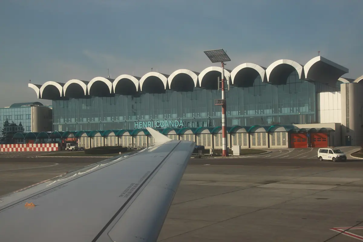 Arched roofline of the airport terminal building seen across the apron