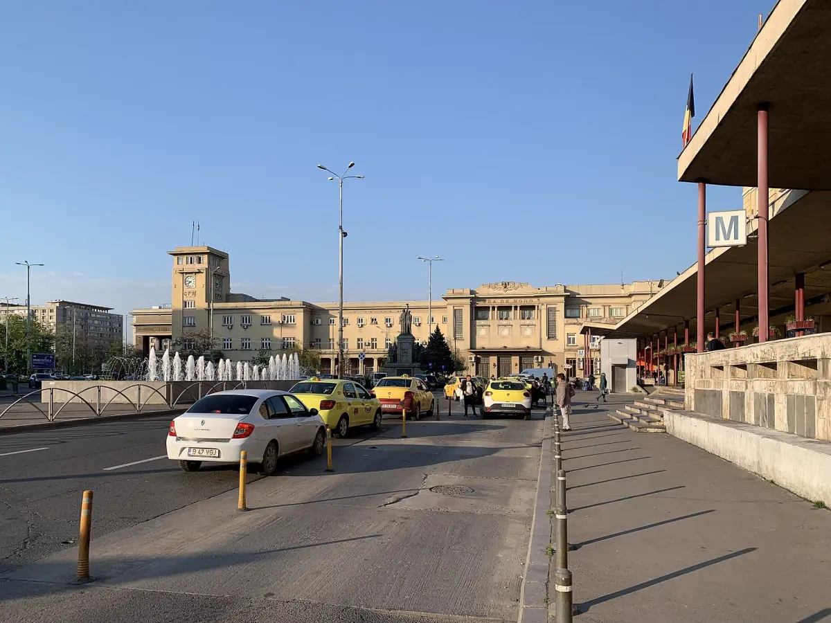 Main railway station building in Bucharest with taxis on the forecourt